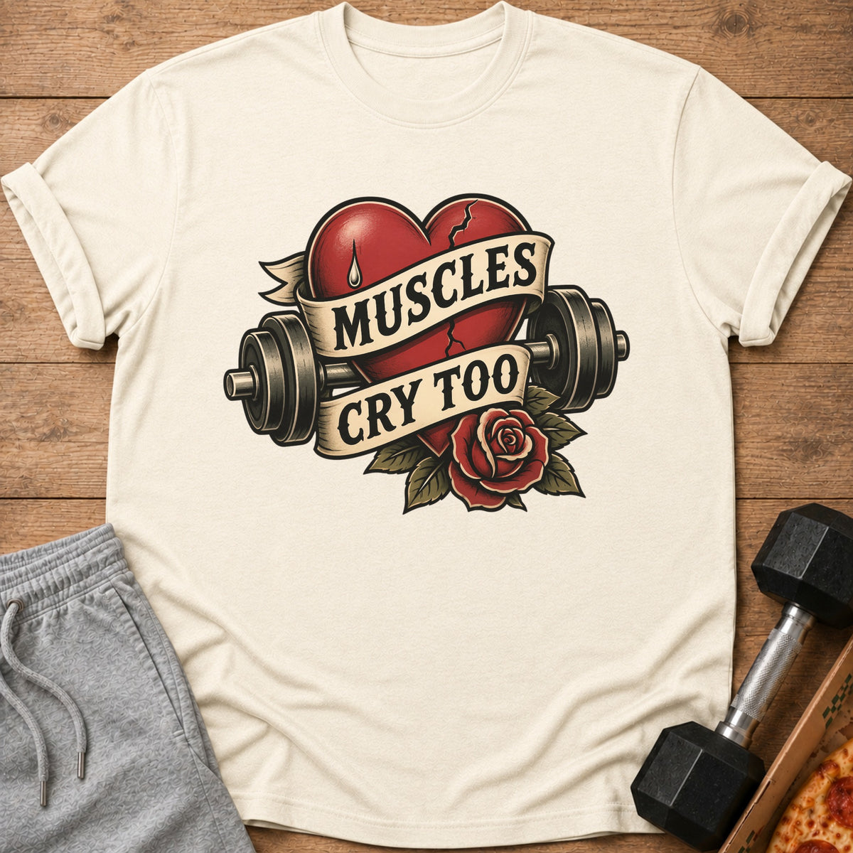 T-shirt with a broken heart graphic featuring dumbbells, rose, and text "Muscles Cry Too."