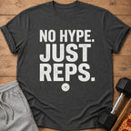 Dark grey t-shirt with white text "NO HYPE. JUST REPS." and a weight plate graphic.