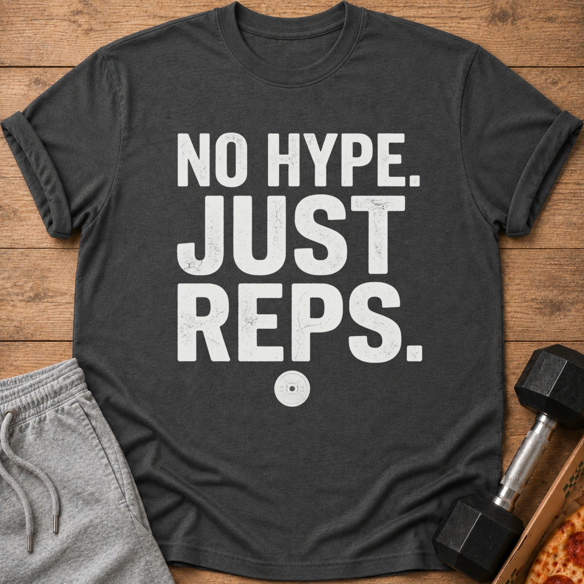 Dark grey t-shirt with white text "NO HYPE. JUST REPS." and a weight plate graphic.