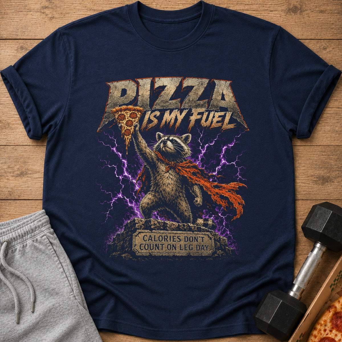 Navy t-shirt with graphic of raccoon holding pizza, text "PIZZA IS MY FUEL."