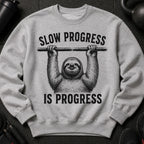 Grey sweatshirt with a sloth hanging from a bar, saying "SLOW PROGRESS IS PROGRESS".