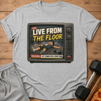 Gray t-shirt with graphic of a person collapsed on a mat inside a vintage TV screen.