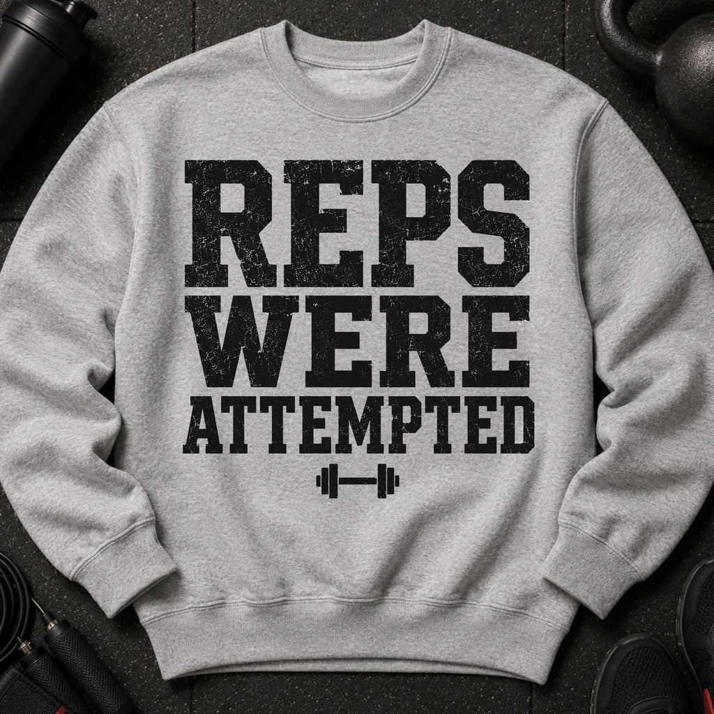 Grey sweatshirt with distressed text "REPS WERE ATTEMPTED" and a dumbbell graphic.