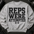 Grey sweatshirt with distressed text "REPS WERE ATTEMPTED" and a dumbbell graphic.