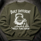 Olive green sweatshirt with white text and graphic of a tired kettlebell.