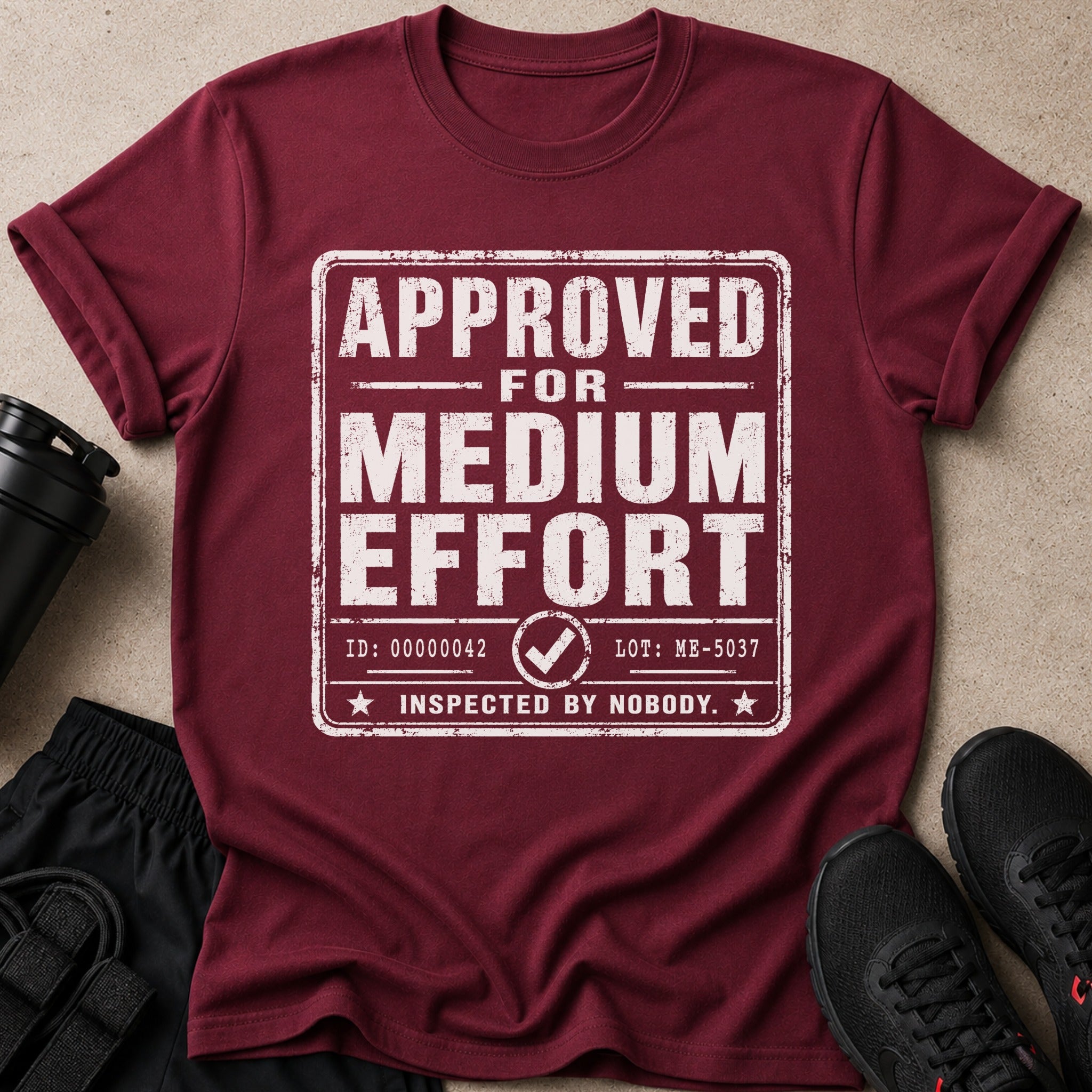 Maroon t-shirt with distressed text "APPROVED FOR MEDIUM EFFORT INSPECTED BY NOBODY."
