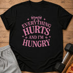 Black t-shirt with pink text "Everything Hurts And I'm Hungry"