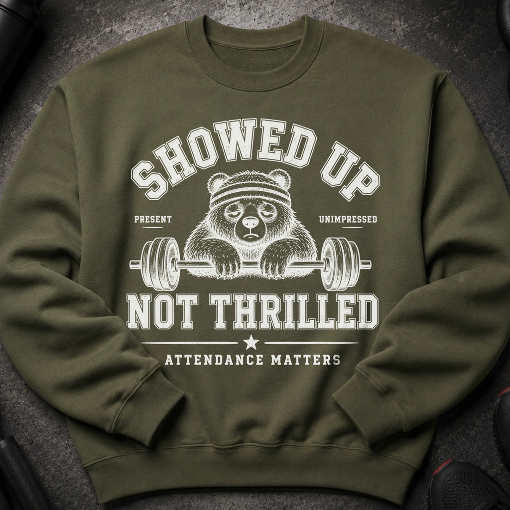 Green sweatshirt with graphic of unenthusiastic panda holding barbell, saying "Showed Up Not Thrilled Attendance Matters".