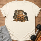 Three kittens around a jack-o'-lantern on an autumn-themed t-shirt.