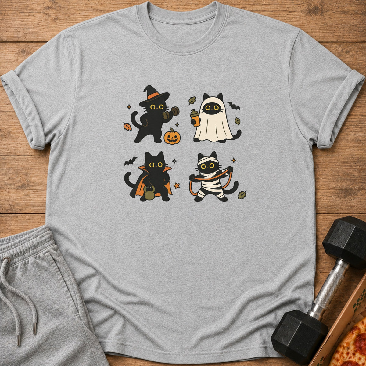 Grey t-shirt with four cartoon cats in Halloween costumes: witch, ghost, vampire, and mummy.
