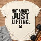 Cream t-shirt with text "NOT ANGRY. JUST LIFTING." and a kettlebell graphic.