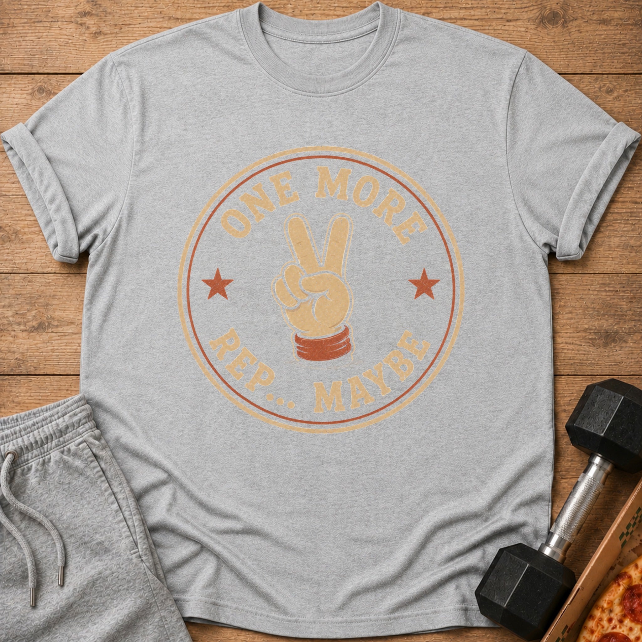 Gray t-shirt with a graphic of a hand giving a peace sign and text "ONE MORE REP... MAYBE".