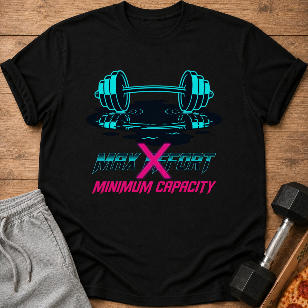 Black t-shirt with turquoise dumbbell and text "MAX X EFFORT MINIMUM CAPACITY"