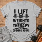 Gray t-shirt with black text "I LIFT WEIGHTS BECAUSE THERAPY HAS OPENING HOURS".