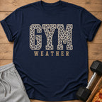 Navy t-shirt with "GYM WEATHER" text in leopard print and gold lettering.