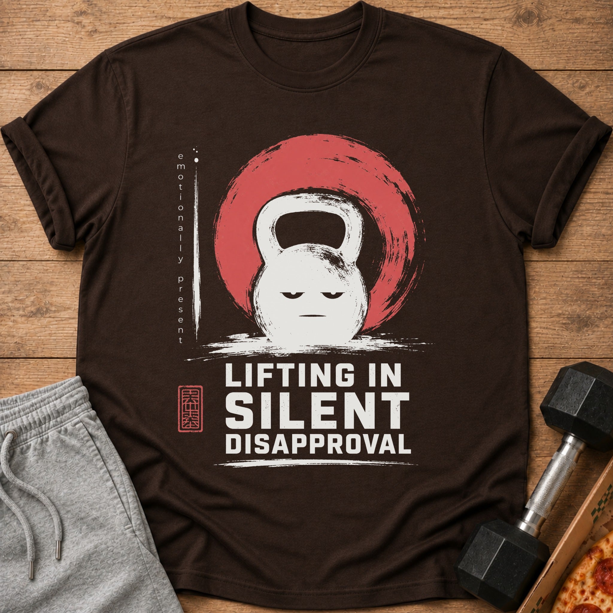 Brown t-shirt with a stern kettlebell graphic and the text "LIFTING IN SILENT DISAPPROVAL."