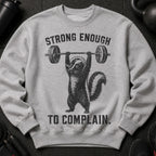 Grey sweatshirt with black graphic of skunk lifting barbell and text that says "STRONG ENOUGH TO COMPLAIN."