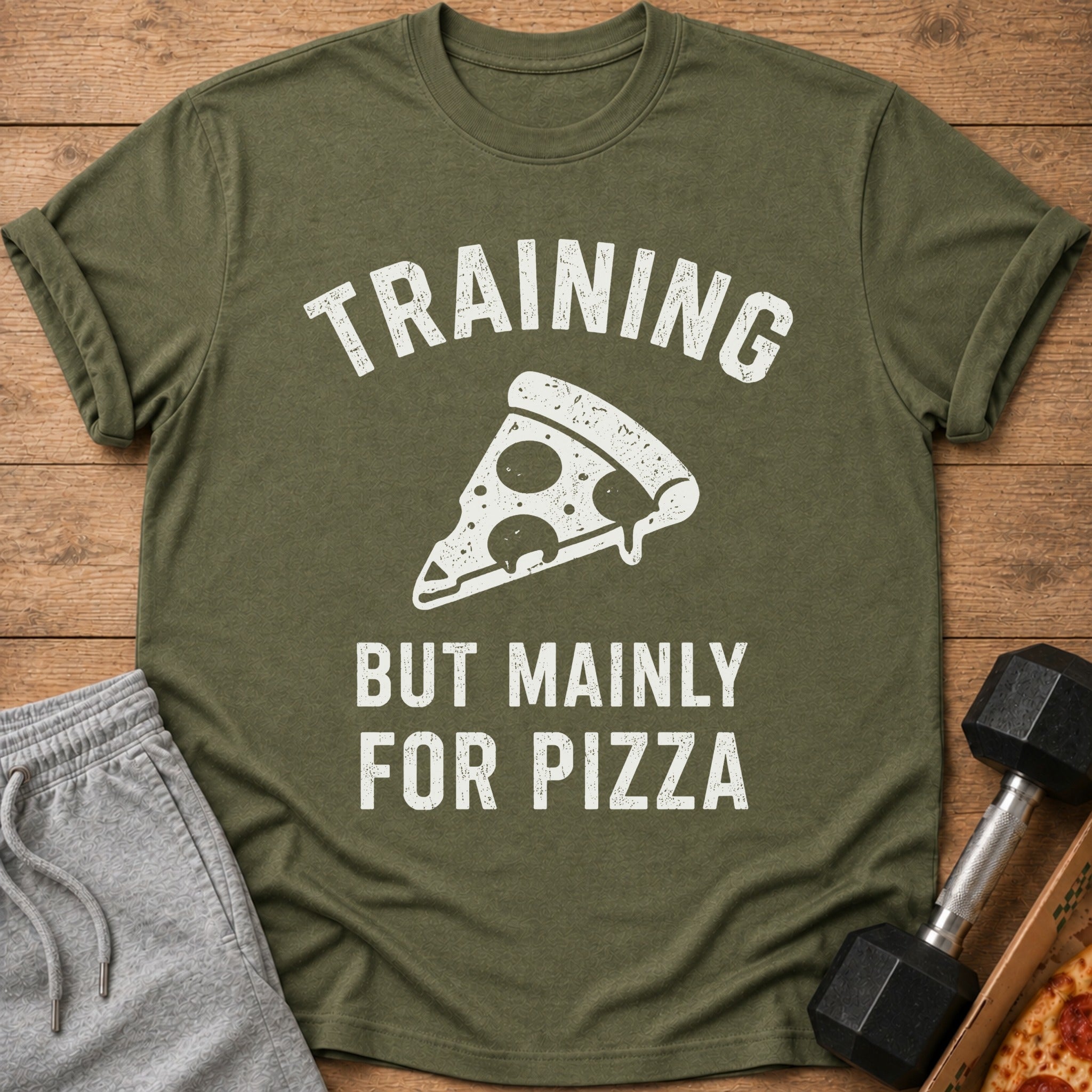 Olive t-shirt with white text "TRAINING BUT MAINLY FOR PIZZA" and a pizza slice graphic.