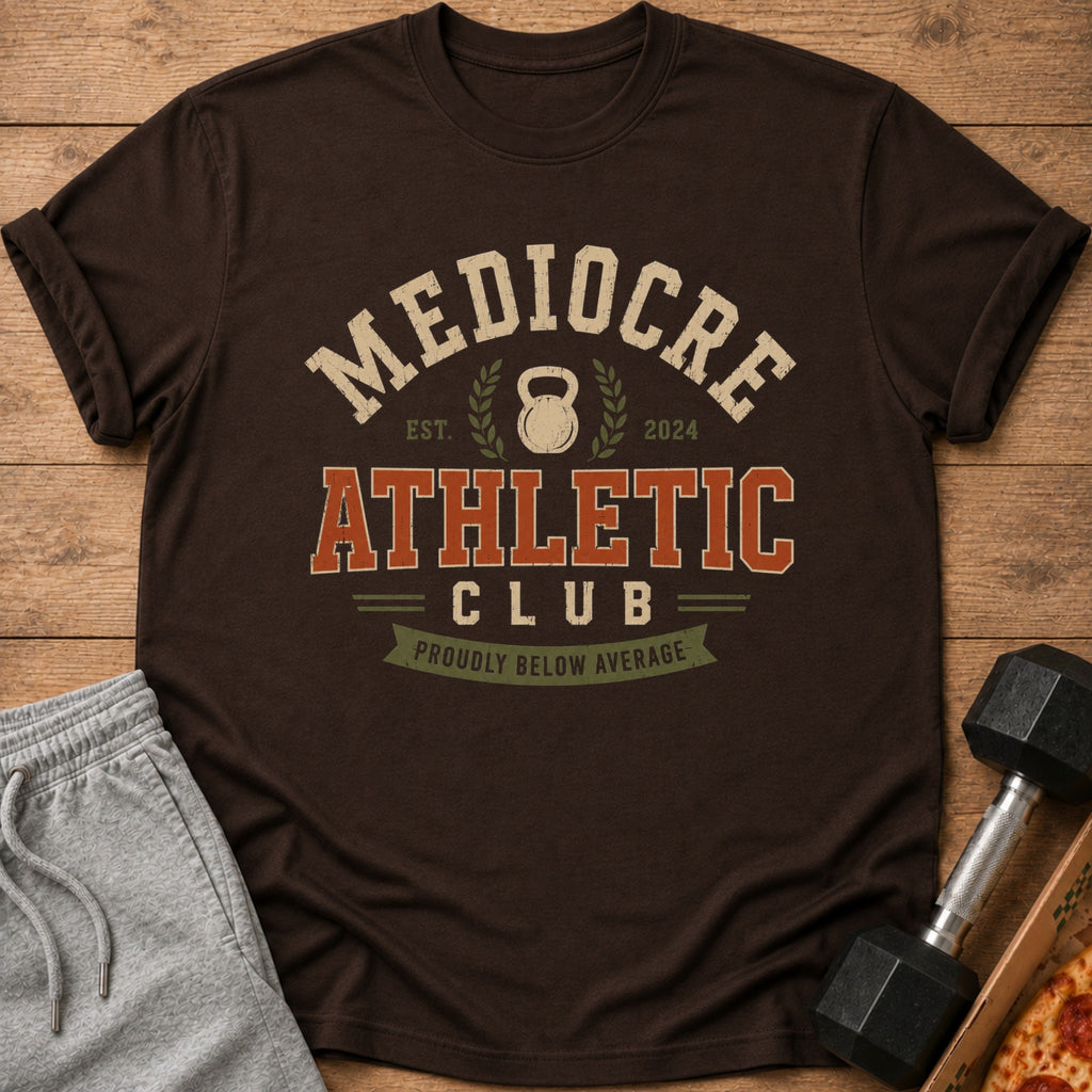 Brown t-shirt with "Mediocre Athletic Club" and "Proudly Below Average" text.