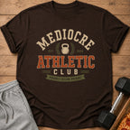 Brown t-shirt with "Mediocre Athletic Club" and "Proudly Below Average" text.