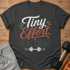 Dark gray t-shirt with "Tiny Effort, Real Credit" and dumbbell graphic.