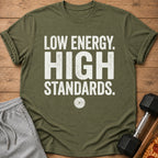 Olive green t-shirt with distressed white text "LOW ENERGY. HIGH STANDARDS."