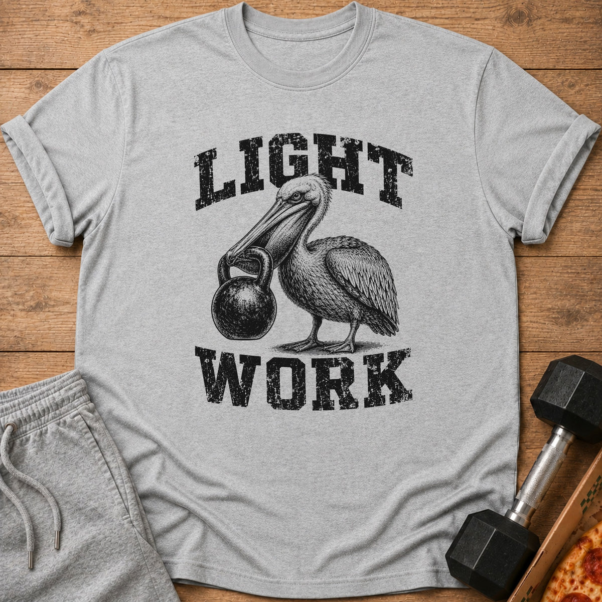 Grey t-shirt with a pelican holding a kettlebell, text says "LIGHT WORK".