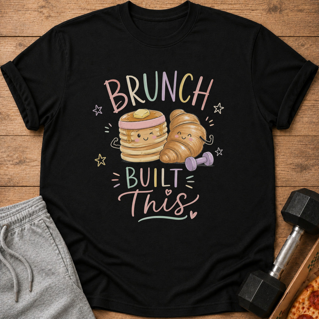 Black t-shirt with "Brunch Built This" text and cartoon pancakes and croissant.