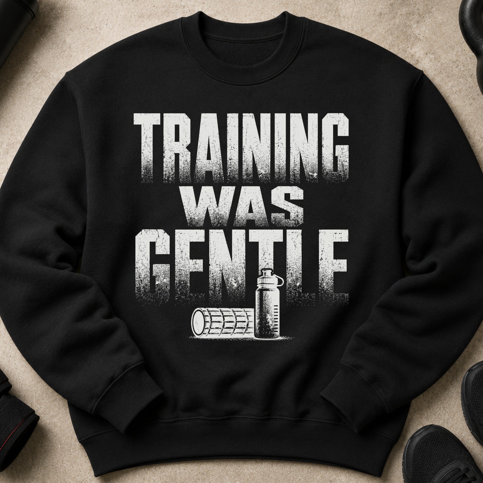 Black sweatshirt with distressed white text "TRAINING WAS GENTLE" and fitness icons.