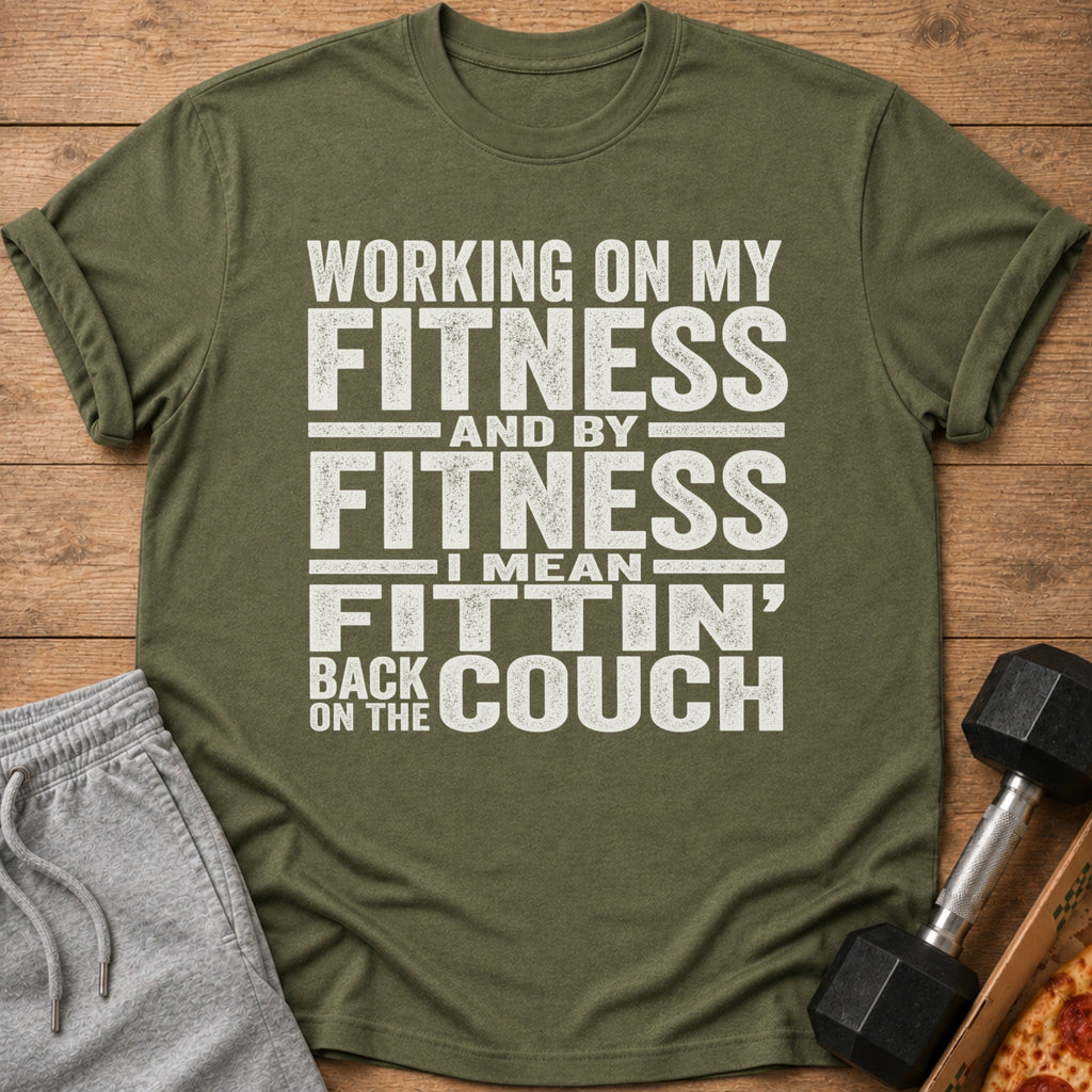 Olive green t-shirt with white text: "Working on my fitness and by fitness I mean fittin' back on the couch."