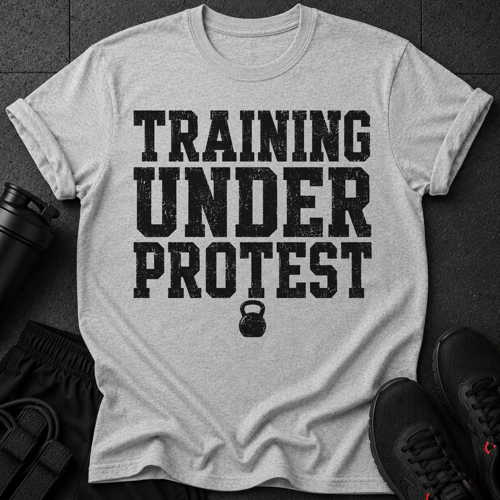 Grey t-shirt with black distressed text "TRAINING UNDER PROTEST" and a kettlebell graphic.