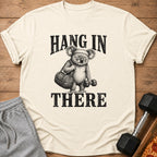 T-shirt with black text "HANG IN THERE" and a drawing of a koala.