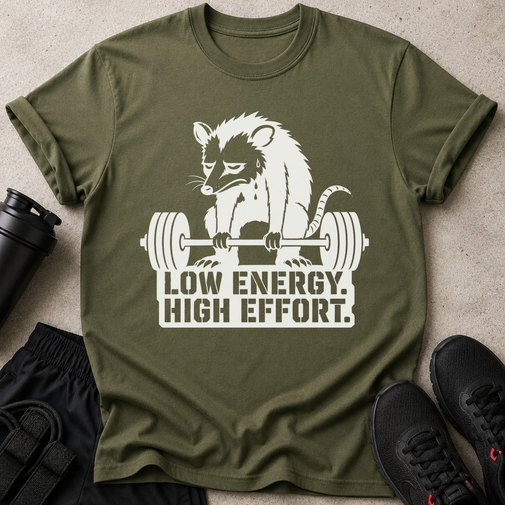 Olive green t-shirt with white graphic of a opossum lifting weights and text "LOW ENERGY. HIGH EFFORT."