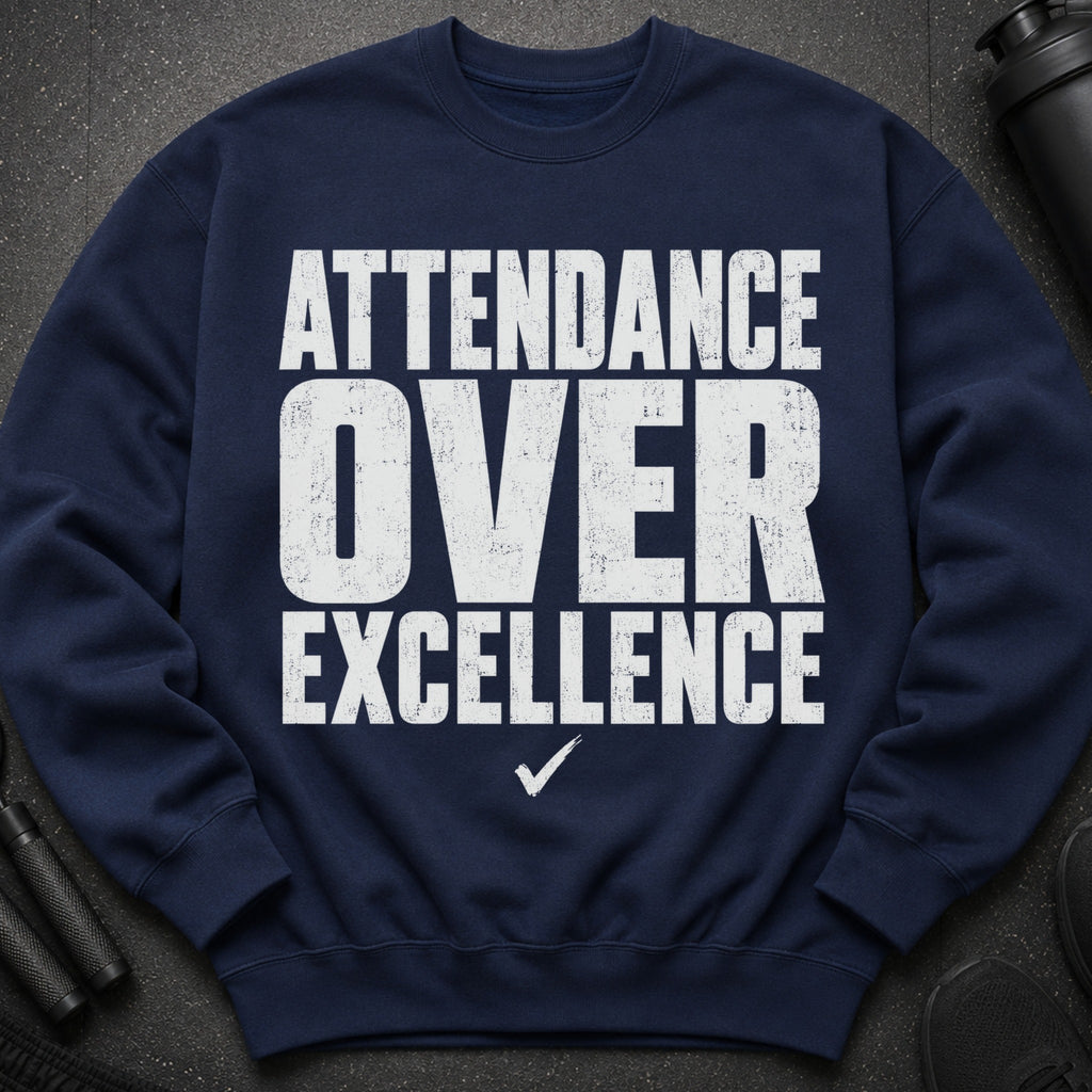 Navy sweatshirt with white text: "ATTENDANCE OVER EXCELLENCE" and a checkmark.