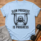 Light blue t-shirt with sloth hanging and text "SLOW PROGRESS IS PROGRESS".