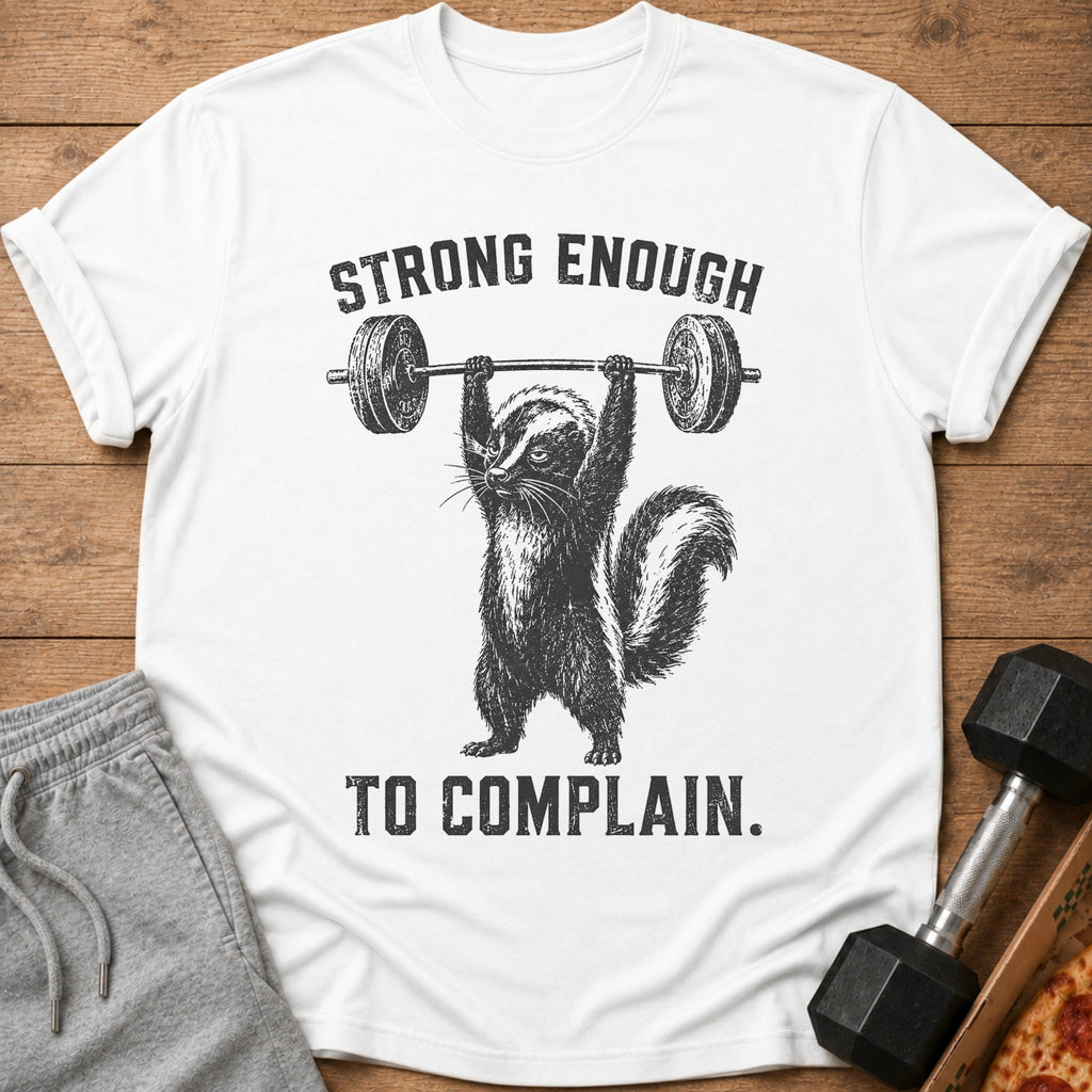 White t-shirt with skunk lifting barbell and text "STRONG ENOUGH TO COMPLAIN."