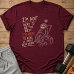 Maroon t-shirt with sloth illustration and text "I'm not here to be the best. I'm here to feel a little less worst."