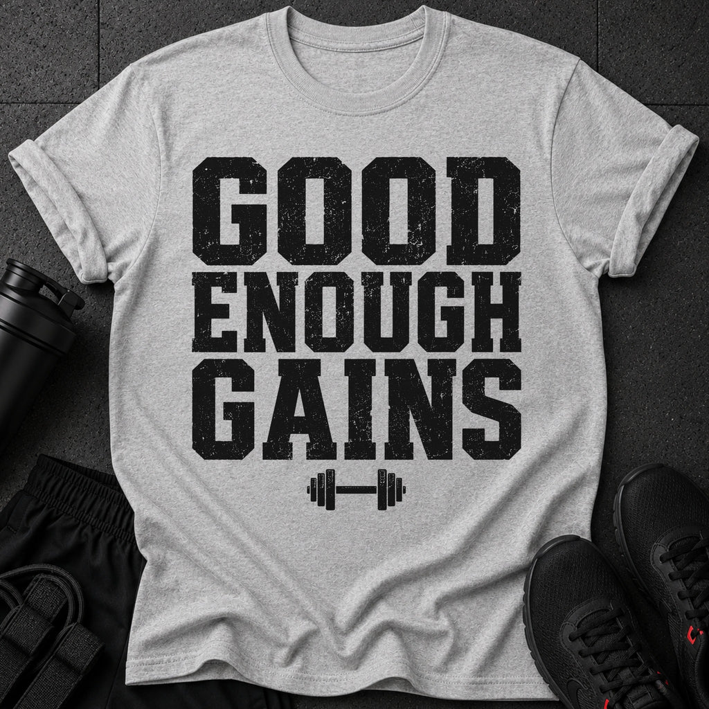 Grey t-shirt with black distressed text "GOOD ENOUGH GAINS" and barbell graphic.