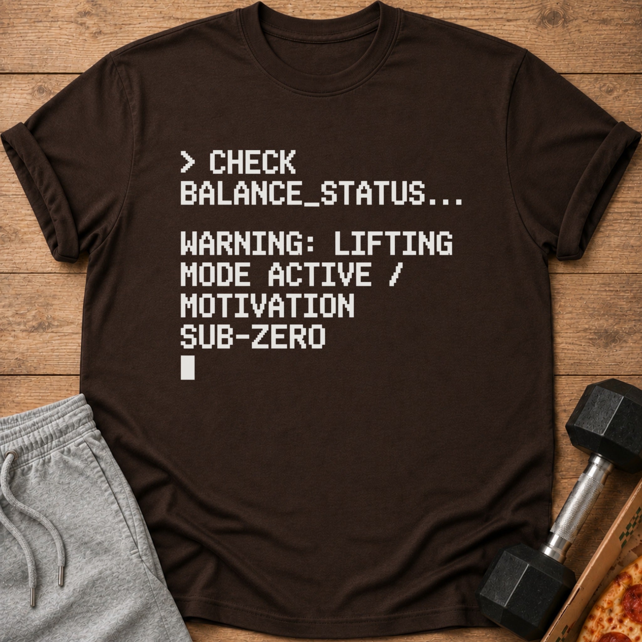 Brown t-shirt with white pixelated text about lifting motivation.