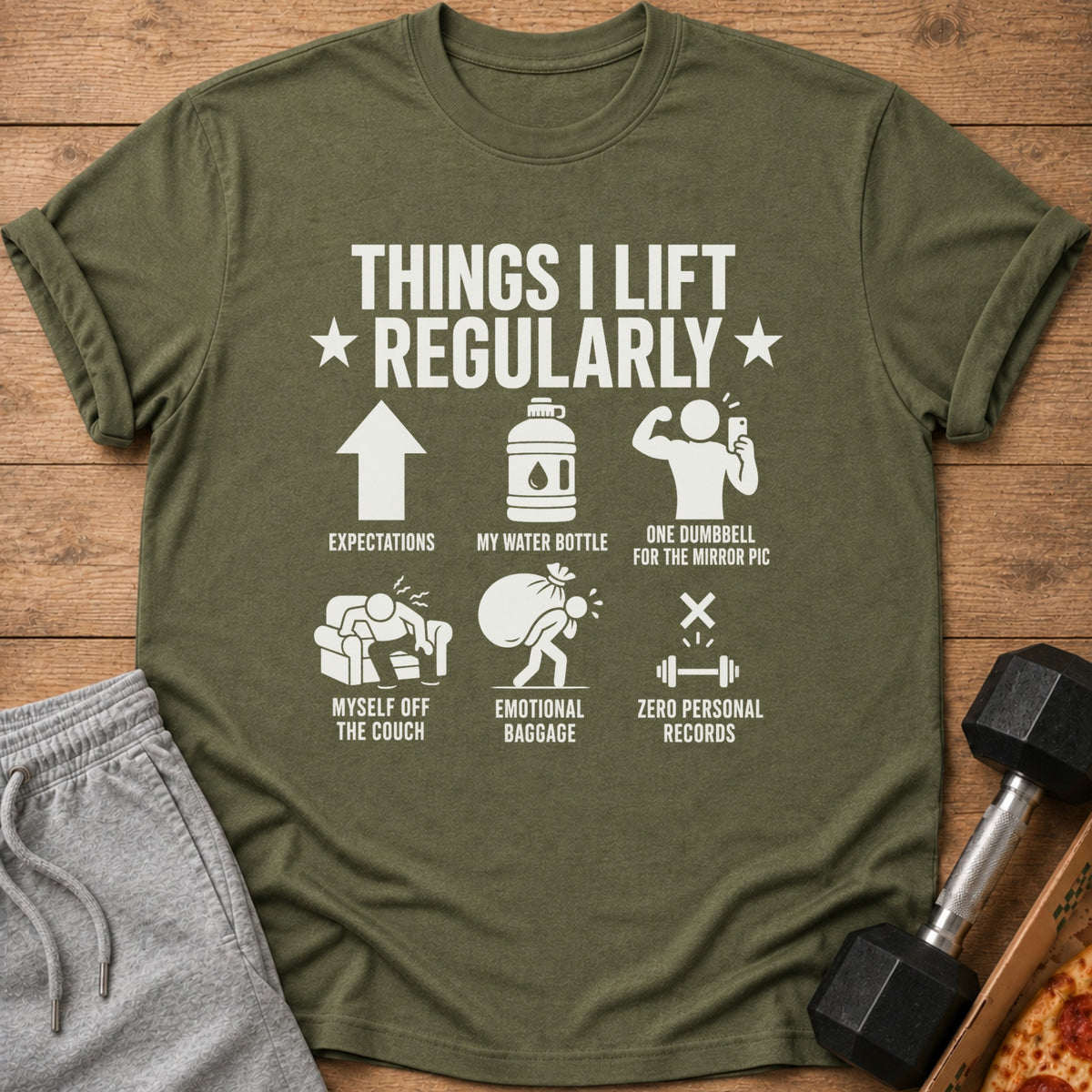 Olive t-shirt with graphic listing "Things I Lift Regularly": expectations, water bottle, mirror pic, couch, baggage, zero records.