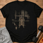 T-shirt with graphic of raccoon wearing sunglasses and headband lifting barbell.