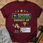 Maroon t-shirt with pixel art "Achievement Unlocked Showed Up" design.
