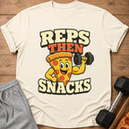 T-shirt with cartoon pizza lifting dumbbell, text "REPS THEN SNACKS."