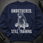 Navy sweatshirt with a line drawing of a capybara lifting weights and text "UNBOTHERED. STILL TRAINING."