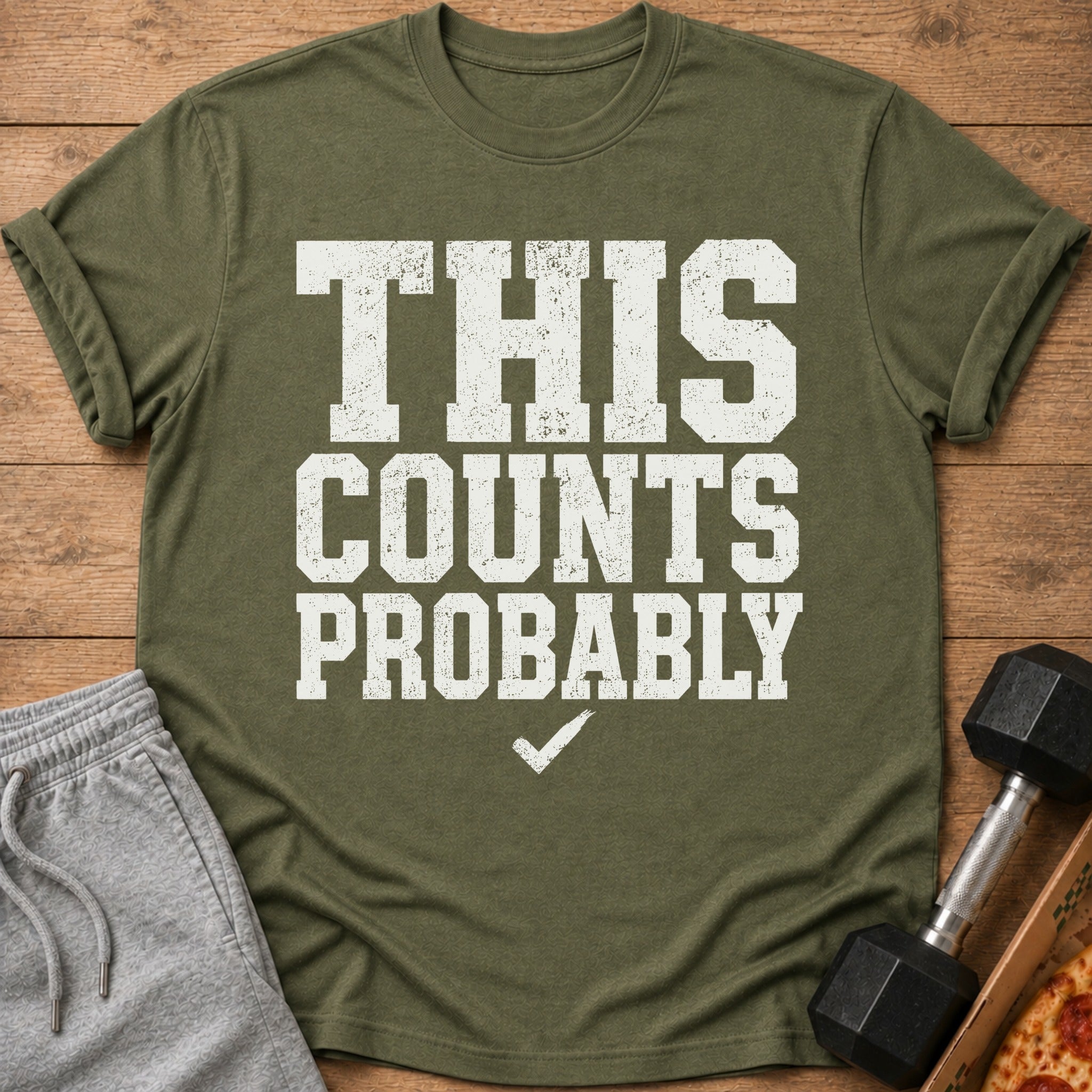 Olive green t-shirt with distressed white text: "THIS COUNTS PROBABLY" and a checkmark.