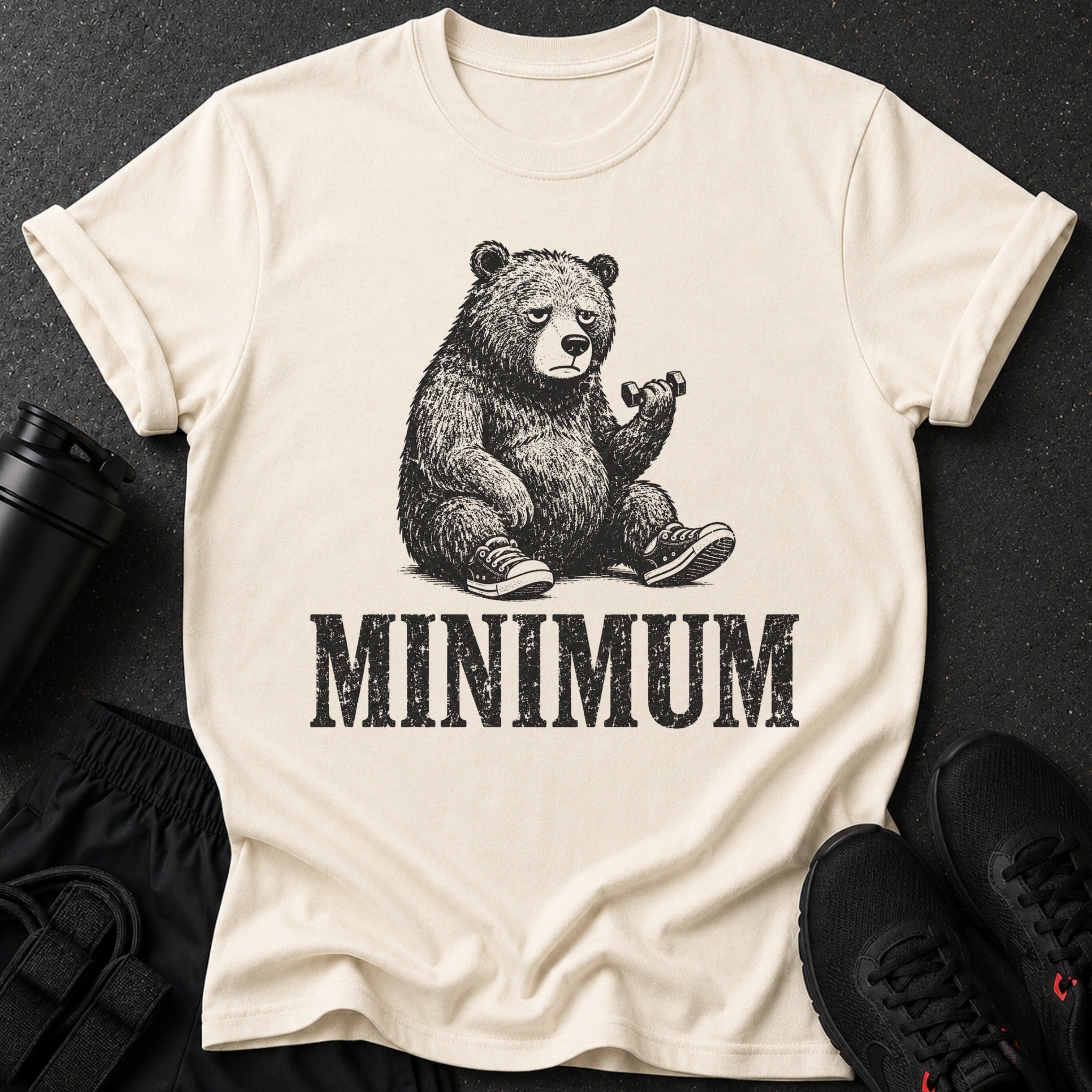 Cream t-shirt with black graphic of bear lifting dumbbell and text "MINIMUM".
