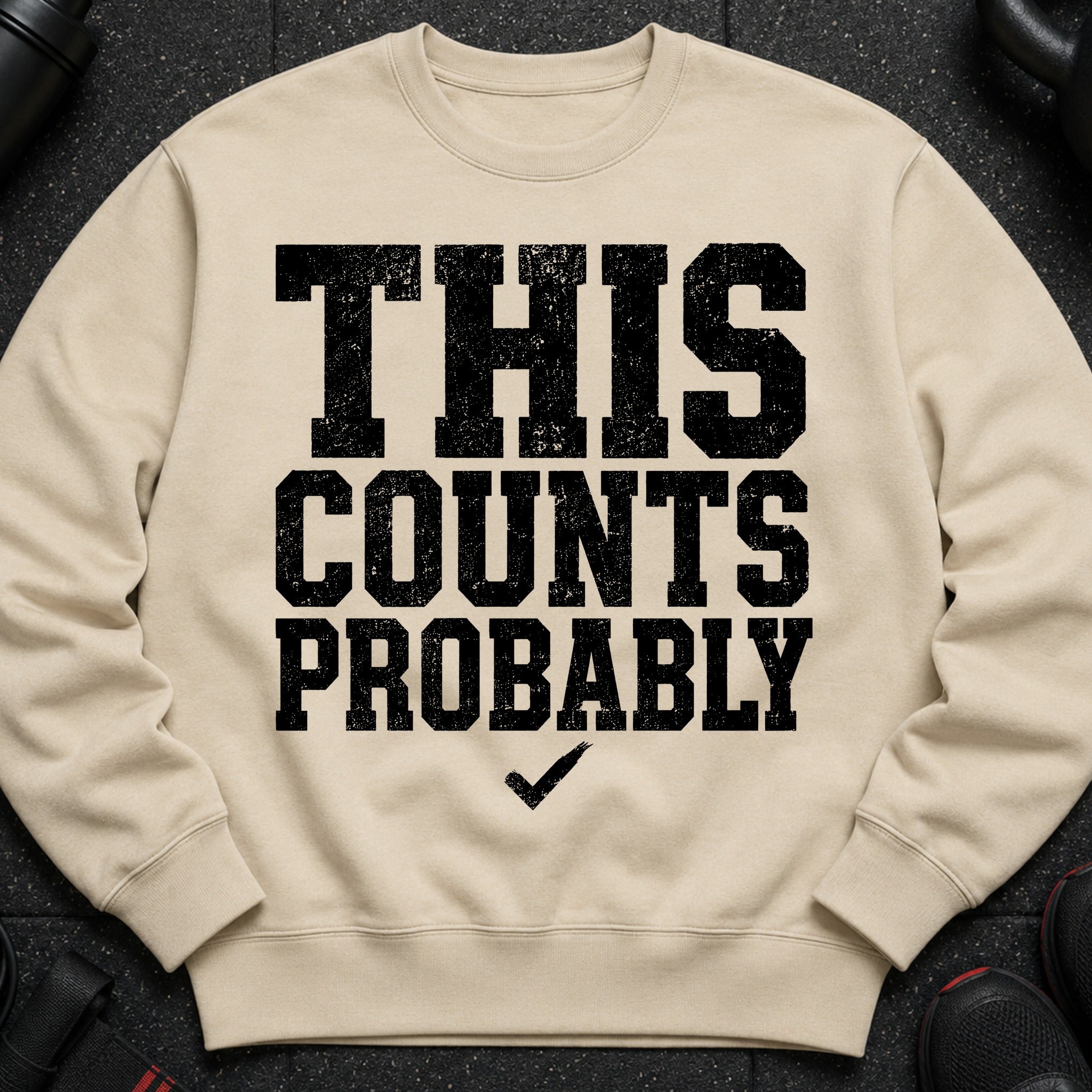 Beige crewneck sweatshirt with black distressed text reading "THIS COUNTS PROBABLY" and a checkmark.