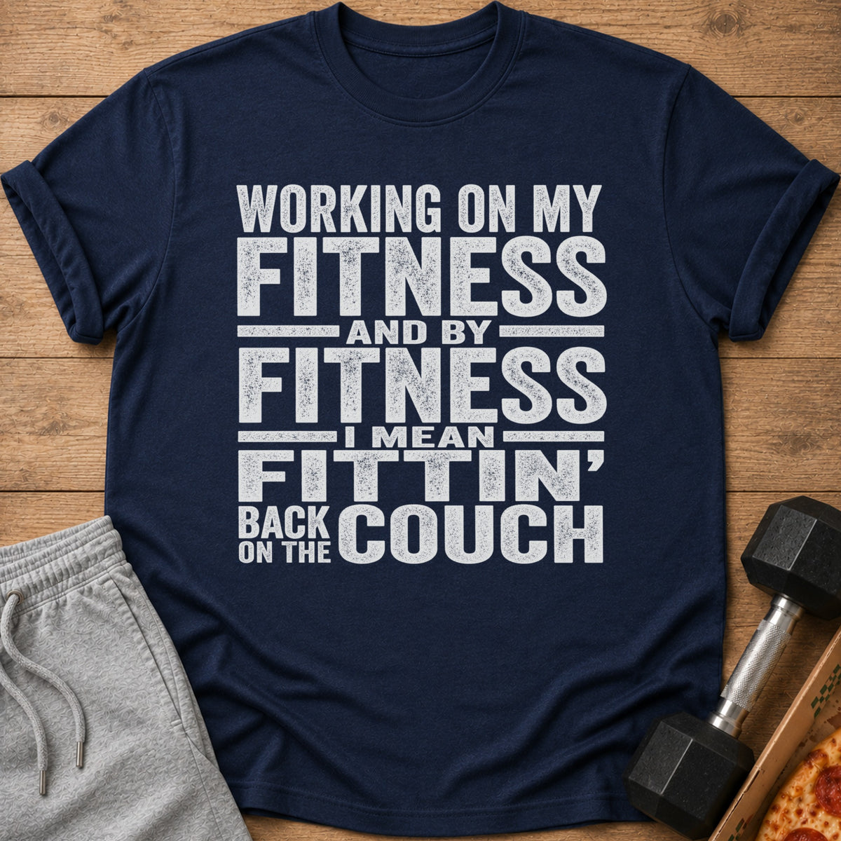 Navy t-shirt with text: "Working on my fitness and by fitness I mean fittin' back on the couch."