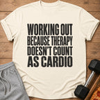 Cream t-shirt with black text: "WORKING OUT BECAUSE THERAPY DOESN'T COUNT AS CARDIO".