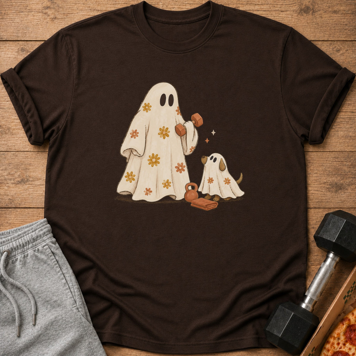 Brown t-shirt with a graphic of two ghosts exercising, holding weights and dumbbells.